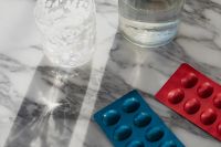Kaboompics - Medicine Blister Packs with Water Glasses on Marble