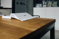 Kaboompics - Bathroom Fixture Brochure Open on a Wooden Showroom Table