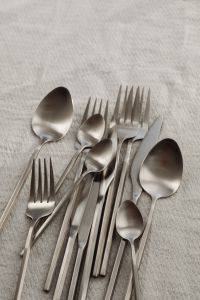 Kaboompics - Overhead Silver Cutlery Still Life on Light Textured Fabric