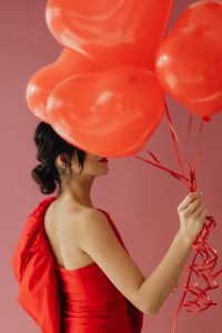 Kaboompics - Back View of Woman Holding Heart Balloons for Valentine’s Day