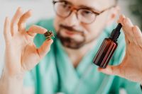 Kaboompics - Doctor With Dropper and Amber Bottle