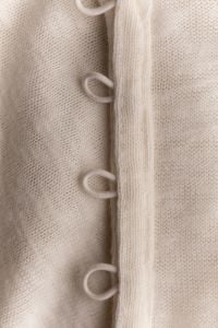 Kaboompics - Beige Knit Garment With Loop Fastening Detail