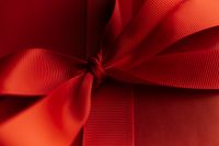 Kaboompics - Macro Red Christmas Gift Wrapping with Ribbed Satin Ribbon Bow Texture
