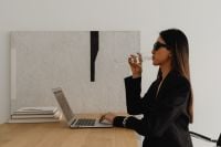 Kaboompics - Woman Drinking Wine Beside a Laptop at a Desk