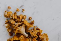 Kaboompics - Fresh Chanterelle Mushrooms On White Marble