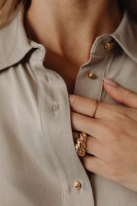Kaboompics - Woman's Hand with Gold Ring on Tan Silk Shirt