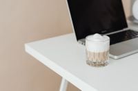 Kaboompics - Laptop and a glass of Cafe Latte on the desk