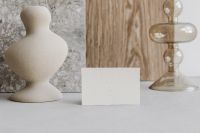 Kaboompics - Neutral Mockup with Blank Card, Sculptural Ceramic Vase, Marble Board and Glass Candlestick