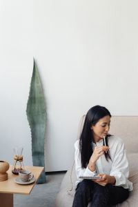 Kaboompics - Woman Taking Notes at a Minimal Coffee Table