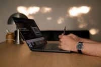 Kaboompics - Faceless Man Working at a Laptop in Warm Light