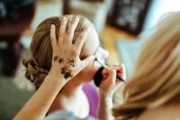 Kaboompics - Beautician putting on make-up on a blonde woman