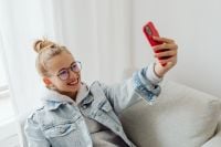 Kaboompics - Teenage Girl Taking Selfie While Studying at Home