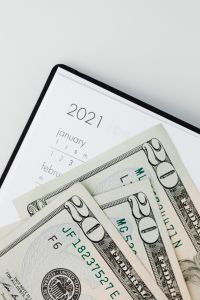 Kaboompics - Cash Bills Spread Across an Open 2021 Diary