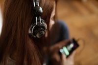Kaboompics - Beautiful young woman in headphones listening to music