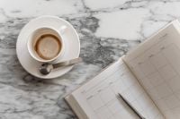Kaboompics - Coffee Cup and Notebook on Arabescato Marble Table