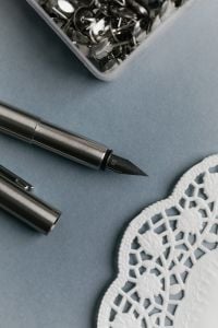 Kaboompics - Writing Tools and Lace Paper Doily on Blue Background