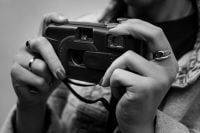 Kaboompics - Close Up Of Hands Holding A Disposable Film Camera