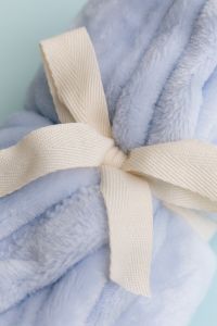 Kaboompics - Soft Blue Blanket Tied With Ribbon Close Up