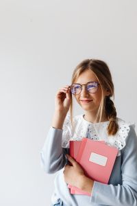 Kaboompics - Schoolgirl with Glasses Holding Her Notebook