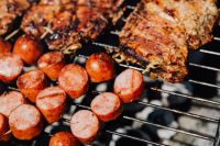 Kaboompics - Extreme Close-Up of Charred Pork Neck and Sausage on a Barbecue Grate