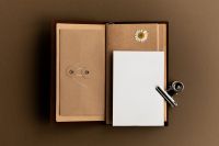 Kaboompics - Open Traveler Notebook with Blank Card and Dried Daisy