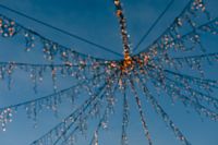 Kaboompics - Close-Up of Hanging Christmas Lights Against Blue Sky