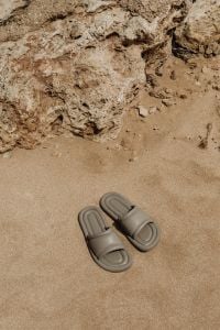 Kaboompics - Beige Slide Sandals with Copy Space on Fine Beach Sand