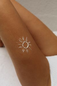 Kaboompics - White Sun Body Paint on a Tanned Leg, Summer Beach Detail