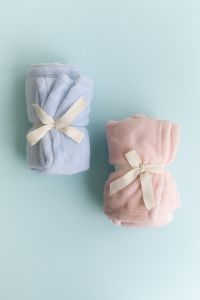 Kaboompics - Blue And Pink Blankets Tied With Ribbon Minimal Composition