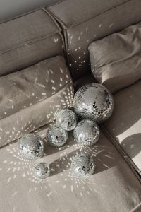 Kaboompics - Close-Up Cluster of Mirror Balls on Gray Sofa Cushions