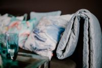 Kaboompics - Close-Up of Blue and Gray Sofa Cushions with Quilted Throw Blanket