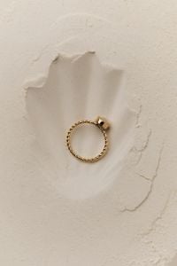 Kaboompics - Gold Ring with a Square Setting in a Flour Impression