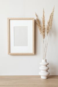 Kaboompics - Minimal Wooden Frame Mockup with Pampas Grass for Poster and Print Design