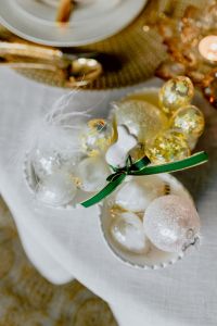 Kaboompics - Vertical Easter Still Life with White Bunny, Green Ribbon and Pastel Glass Egg Ornaments