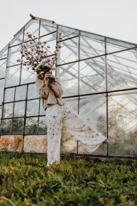 Kaboompics - A beautiful tall woman holds cotton branches