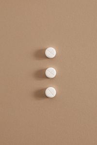 Kaboompics - Three White Scored Tablets on a Beige Background