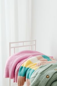 Kaboompics - Colorful Folded Sweaters on a White Rack