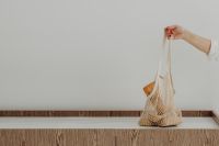 Kaboompics - Hanging Mesh Grocery Bag Filled with Fresh Bread