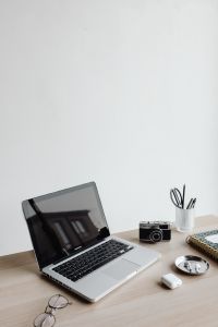 Kaboompics - Minimal Desk with Laptop, Camera, Notebook and AirPods