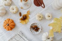 Kaboompics - Autumn Flat Lay of Orange and White Mini Pumpkins, Acorns and Dried Leaves on Linen