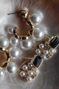 Kaboompics - Assorted Pearl Earrings with Gold, Crystal and Black Stone Details
