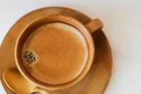 Kaboompics - Overhead Brown Coffee Cup with Golden Spoon and Foam