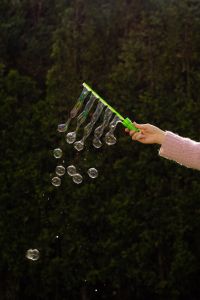 Kaboompics - Hand in Pink Sweater Holding a Multi-Loop Bubble Wand