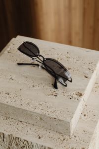 Kaboompics - Black Sunglasses on a Travertine Pedestal