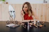 Kaboompics - Soft Focus Beauty Scene of a Woman Applying Lipstick at a Makeup Vanity
