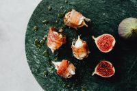 Kaboompics - Prosciutto-Wrapped Figs And Fresh Fig Halves On Slate