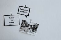 Kaboompics - Overhead Flat Lay of “Less Is More” Typography, Urban Street Photography and White Copy Space
