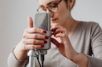Kaboompics - Woman Adjusting a Silver Microphone before Whispered ASMR Recording