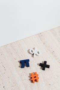 Kaboompics - Colorful Math Operators and Percent Symbols on Neutral Stone for Teaching and Learning Projects