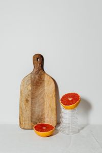 Kaboompics - Grapefruit on a Glass Pedestal Beside a Board for Minimal Food Styling